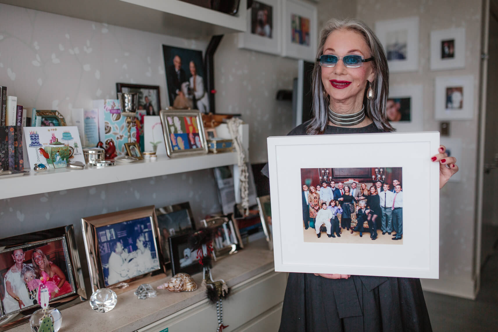 Image of grandmother holding a family photo teaching Passing Down Traditions from Generation to Generation