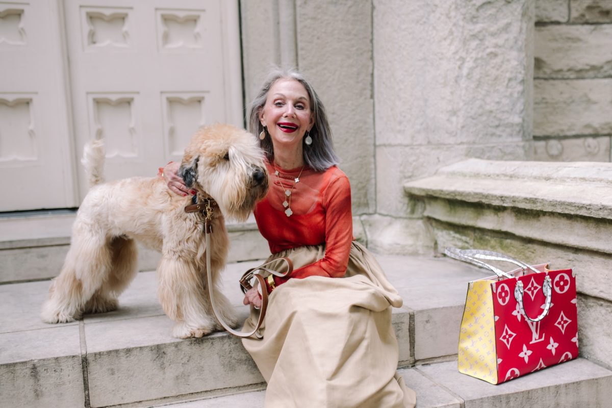 fasionable woman with gray hair smiling with her dog