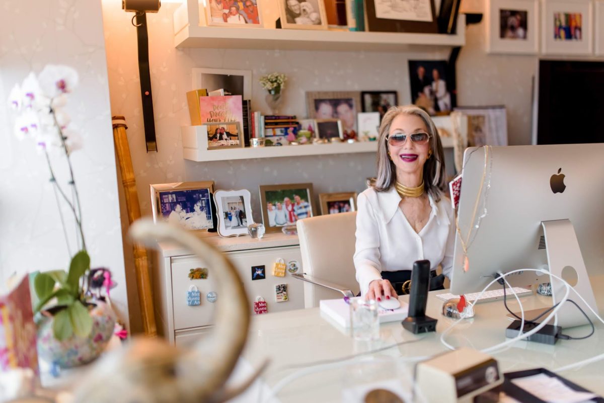 Woman (Honey Good) at her home office, a large Mac desktop computer