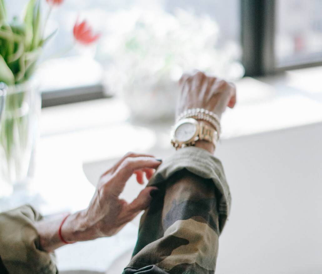 Honey Good's arm with bracelets and watch statement accessories