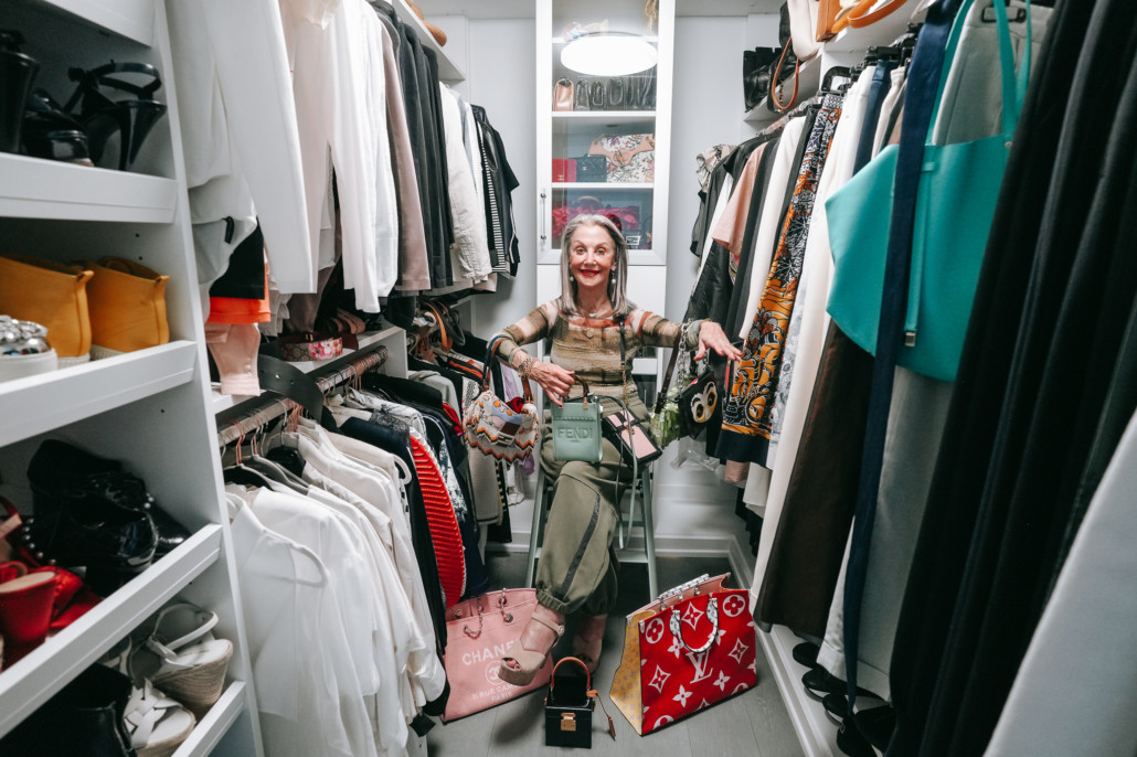 Image: Honey Good in her closet surrounded by accessories including her favorite belt bags.