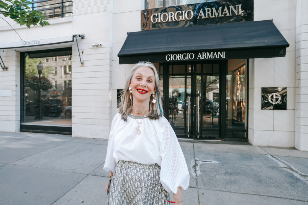 Honey Good outside of Giorgio Armani shop, smiling and enjoying 2023