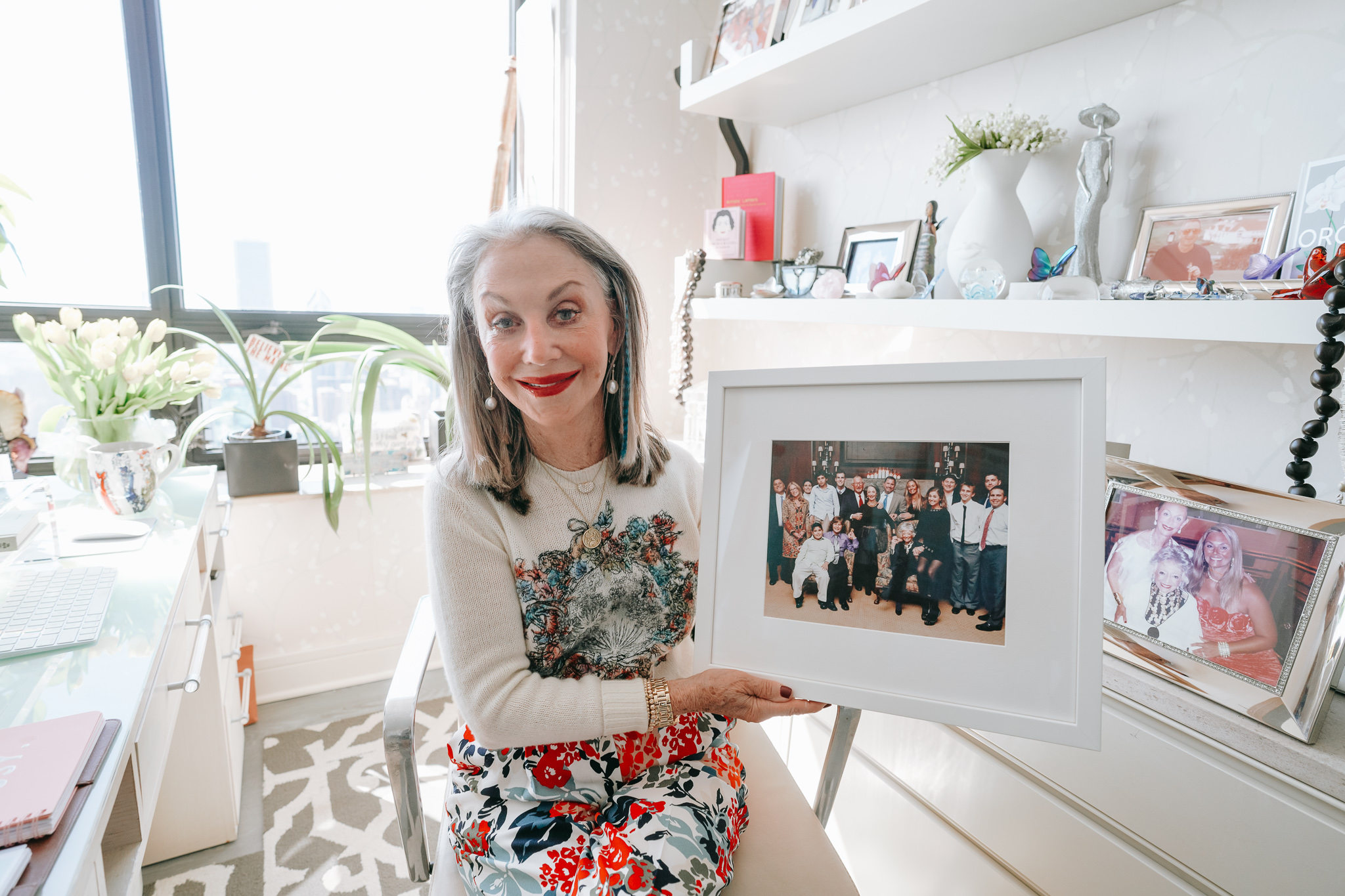 Honey Good holding a picture frame of her family