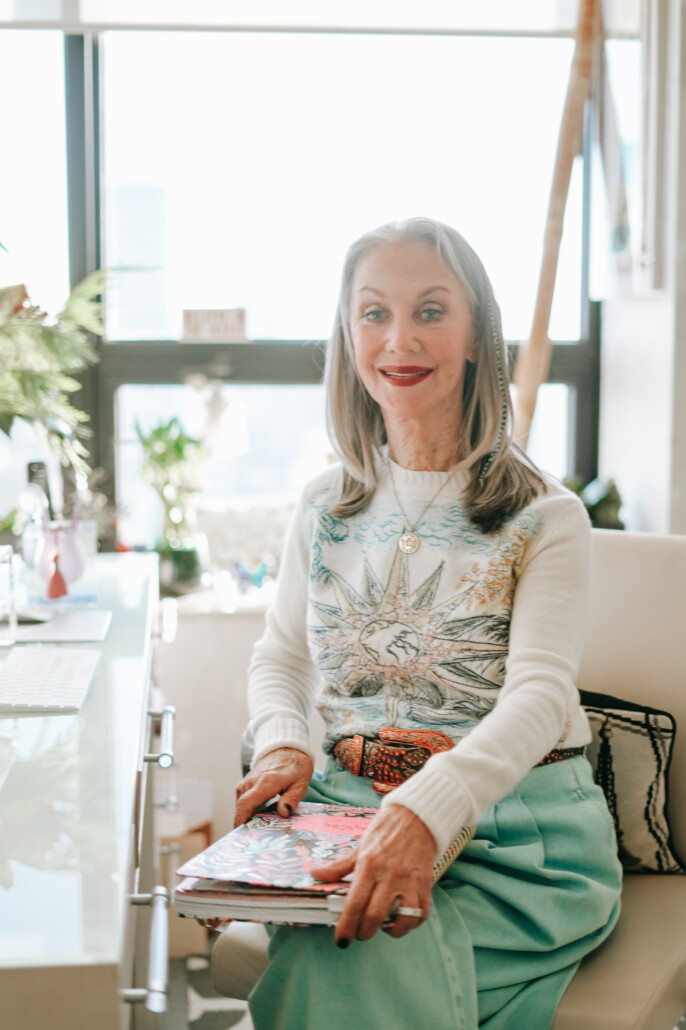 Honey Good sitting at desk holding book taking the high road