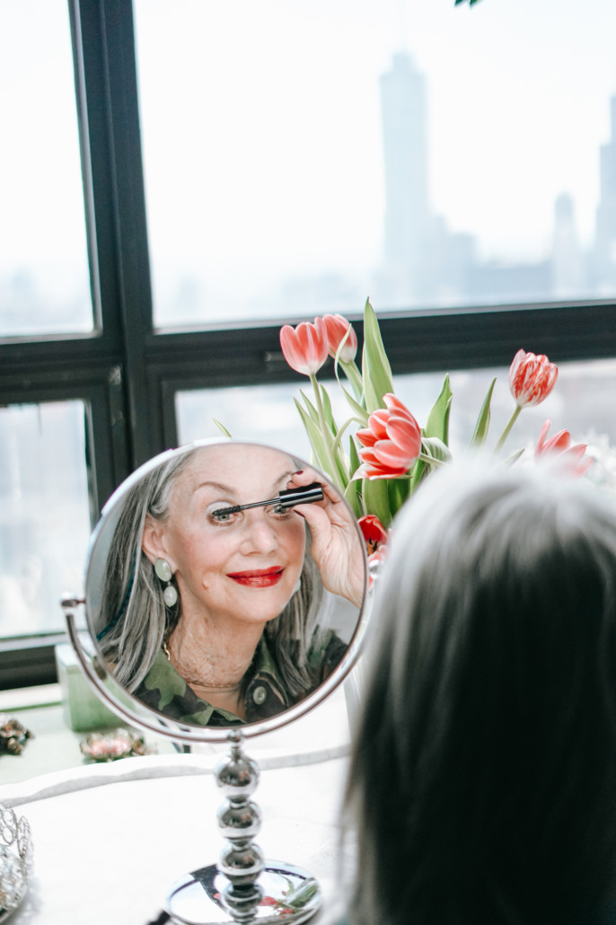 Honey Good focusing on her best makeup tips for women over 50 while applying mascara