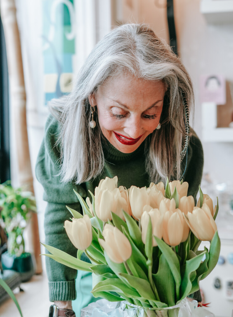 image of honey good setting down a vase of tulips to add a touch of nature for a hygge touch