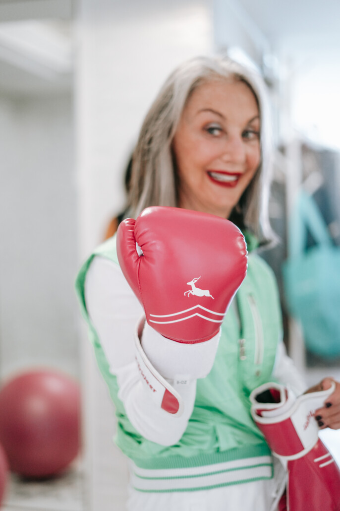 Honey Good holding up pink boxing glove