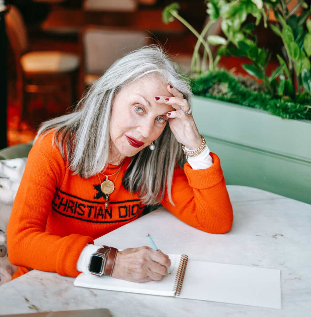 Honey Good writing her thoughts with a melancholy look, musing on why her daughters are estranged from her family estrangement