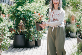 Honey Good holds a plant at a garden center signifying how you can become authentically you this spring