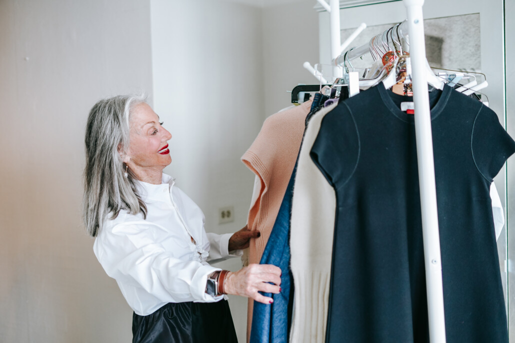 image: Honey good looking through rack of clothes including cocktail dresses for women over 50