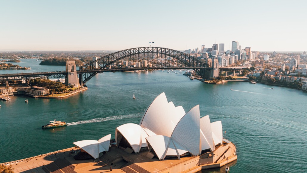 female solo travel to sydney opera house near body of water during daytime