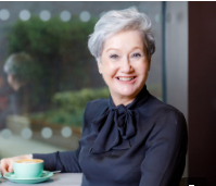 Head shot of mature woman drinking tea