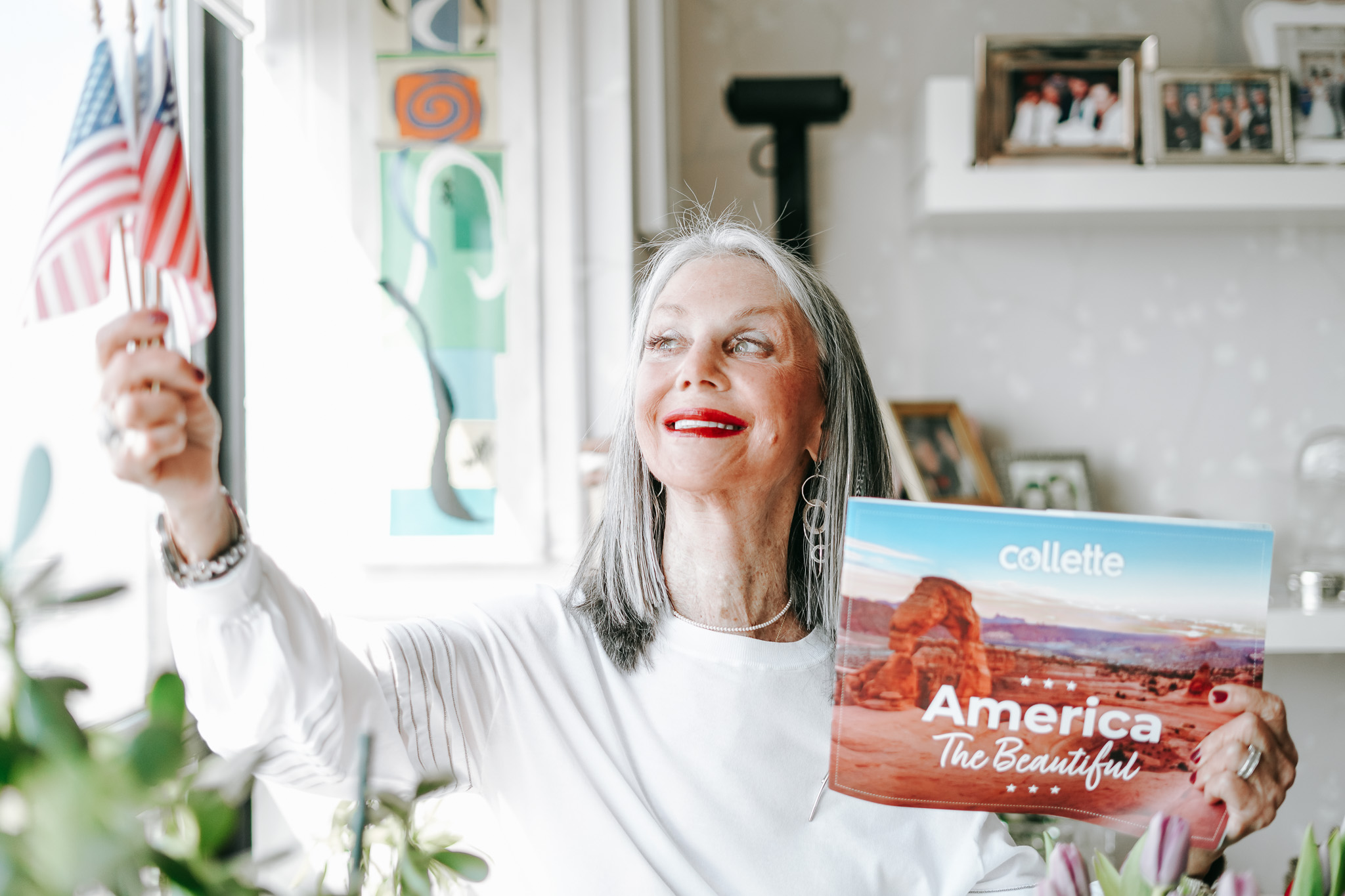 Image of honey good holding an American flag and a travel book describing hidden travel gems