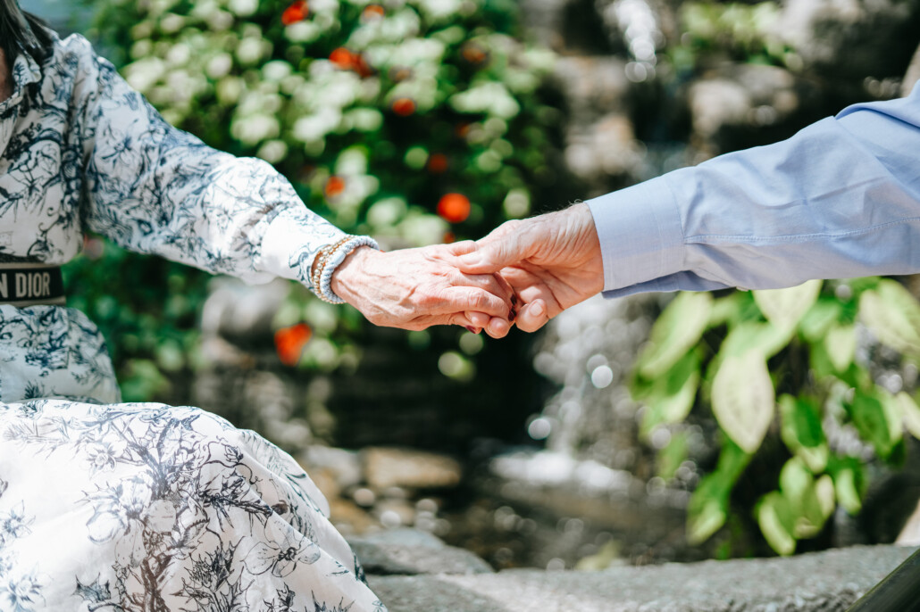 holding hands in a garden