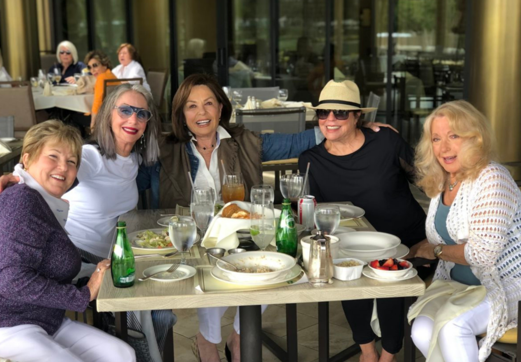 honey sitting with friends at a table