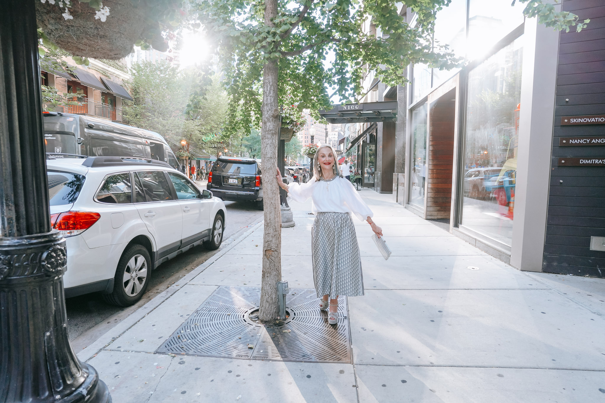 Honey Good standing against tree white shirt and skirt. While she is an older women, she does not choose to wear short skirts, but that doesn't mean she doesn't believe they are right for some people.