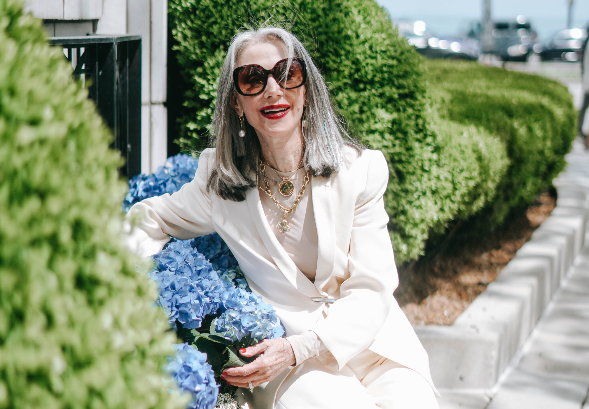 Honey sitting in front of flowers