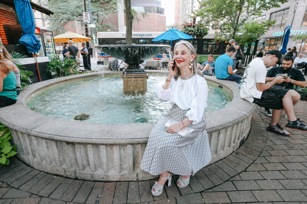 Honey on the phone by a water fountain