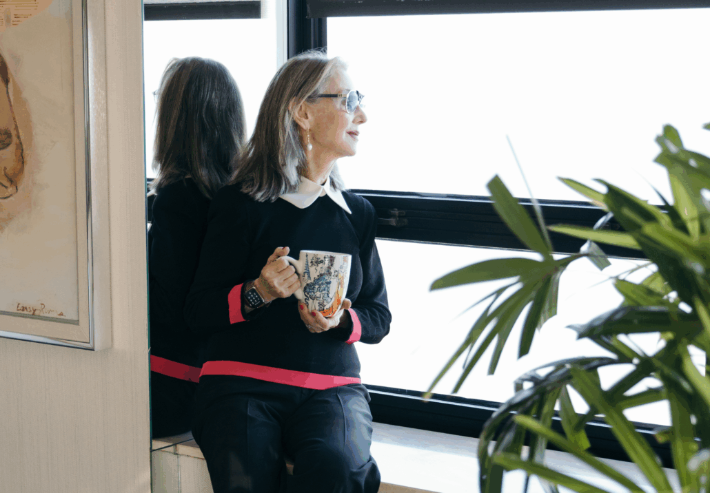 Honey focusing on self care and looking out her window with a cup of coffee and being thankful
