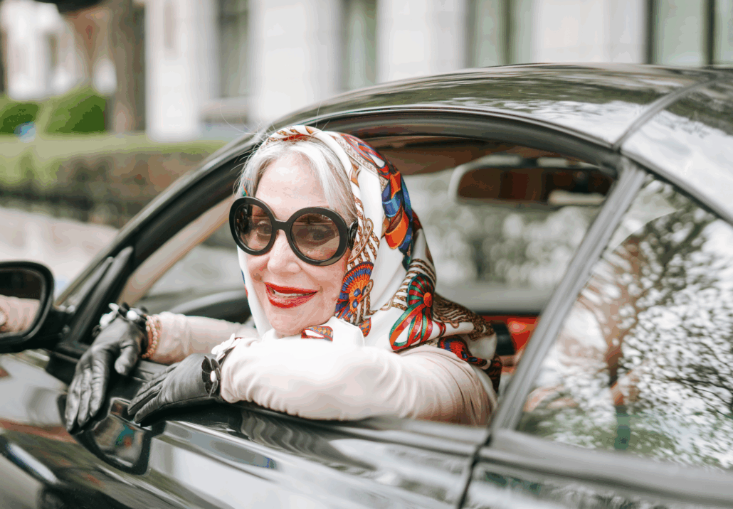 Honey driving a car and smiling