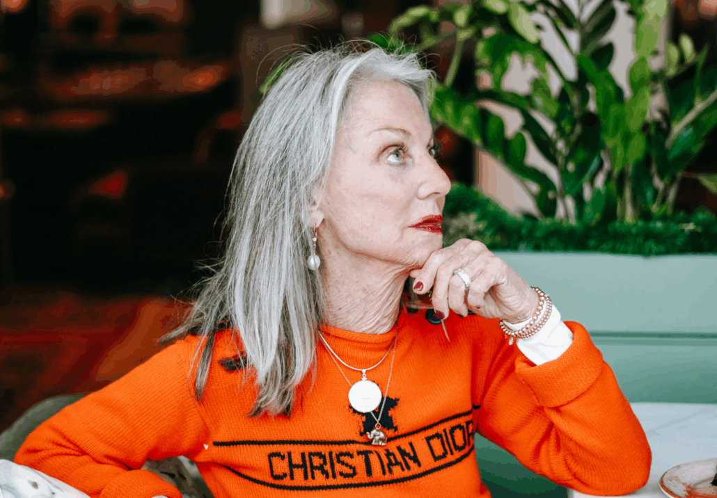 Honey thinking in an orange sweater