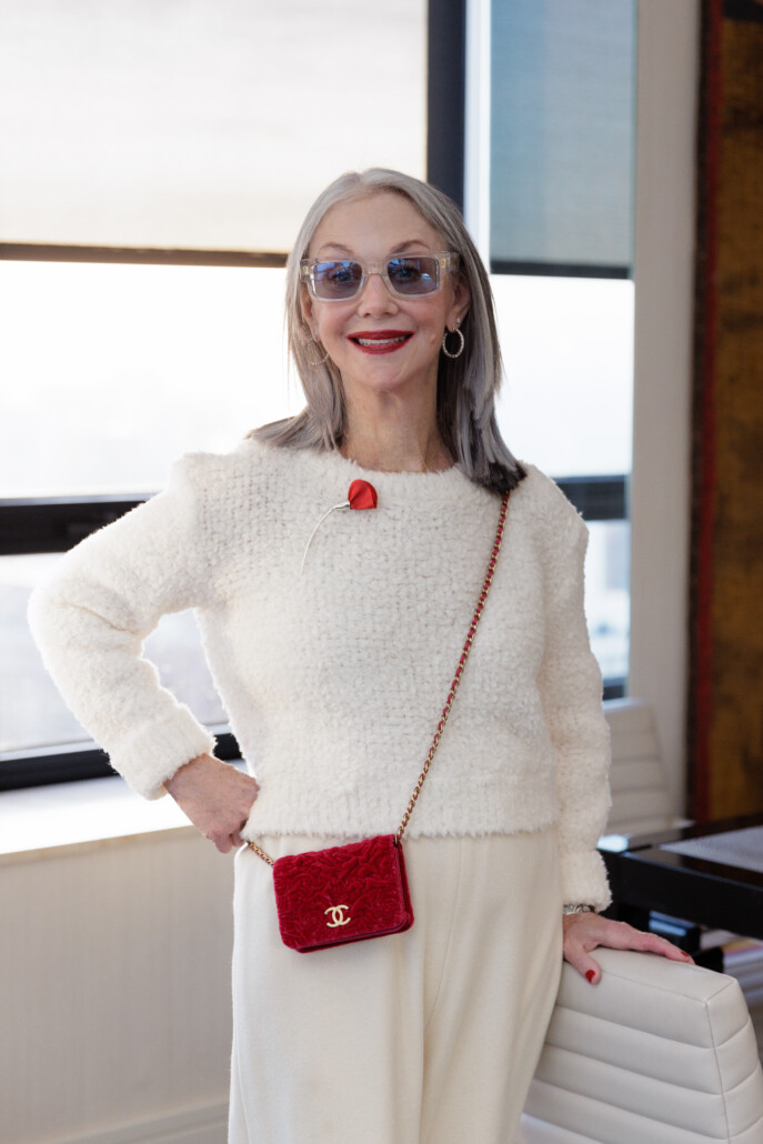 Honey in a white outfit and red purse